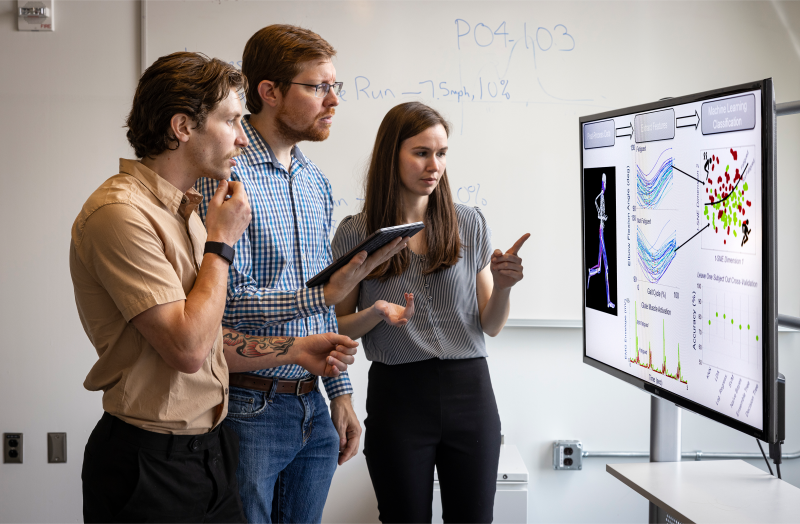 The analysis team — from left, John Clark, Jason Lee and Nikki Steiner —​ discuss the workflow used to classify physical fatigue from measurements of an individual's physiology and biomechanics.