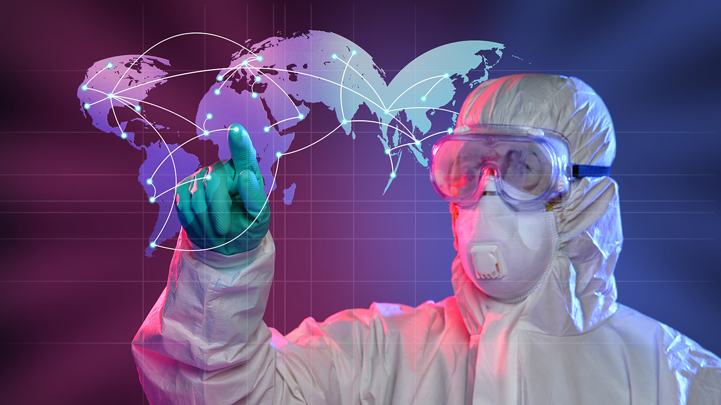 Scientist in a hazmat suit points to a virtual map (Credit: Bigstock)