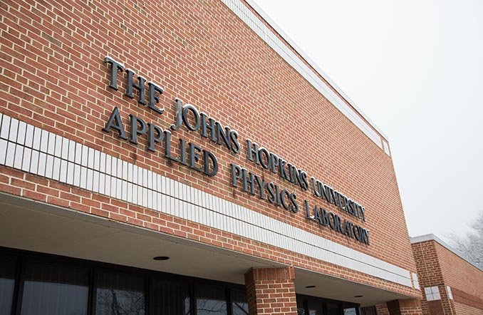 Johns Hopkins Applied Physics Lab title on a red brick building
