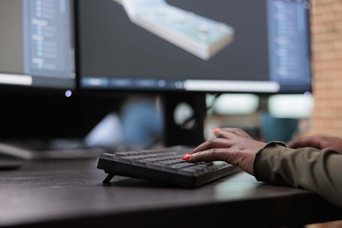 Closeup of person's hands at keyboard and using CAD tool (Credit: Bigstock)