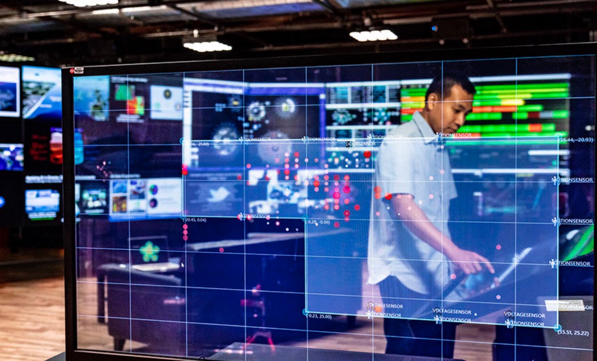 An APL staff member manages the displays in the LIVELab