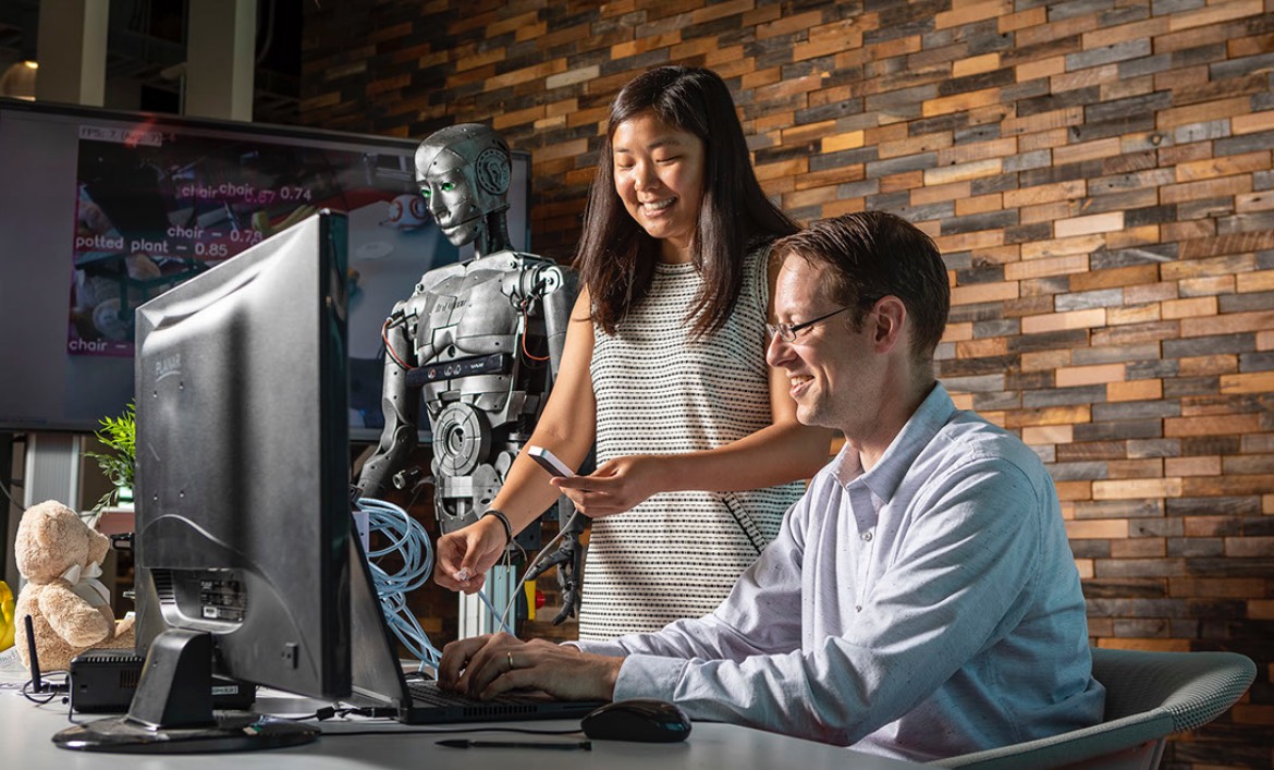 An APL staff member works with a college intern on a programming project