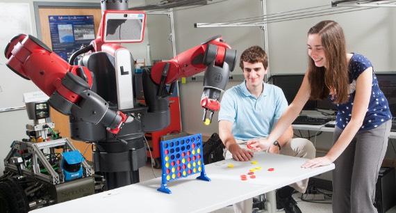 Two young APL staff members experiment with a robot