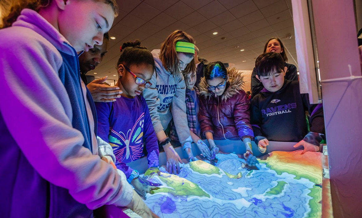 Children interacting with a science exhibit at a Girl Power Event