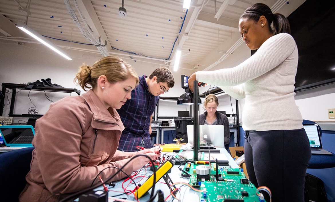 A group of JHU EP students work on an engineering project together