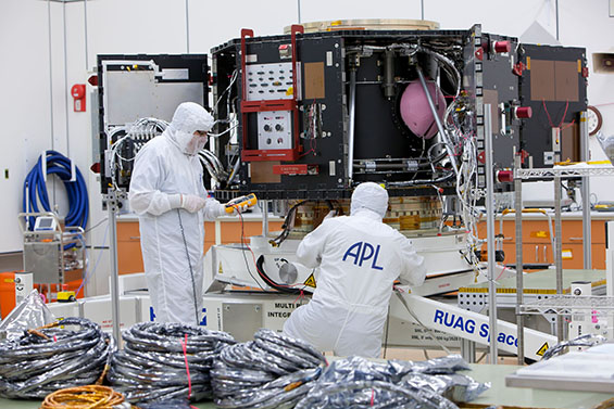 Two APL scientists working in white coats in lab