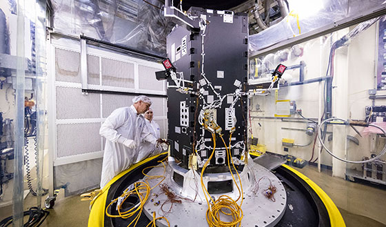 Two scientists prepping the therm vac for the propulsion system