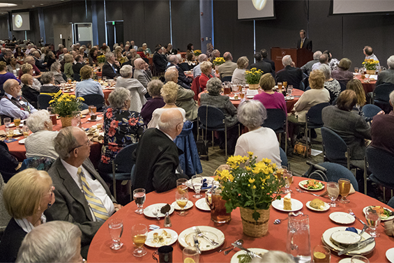 Retirees seated at a table during a reception.