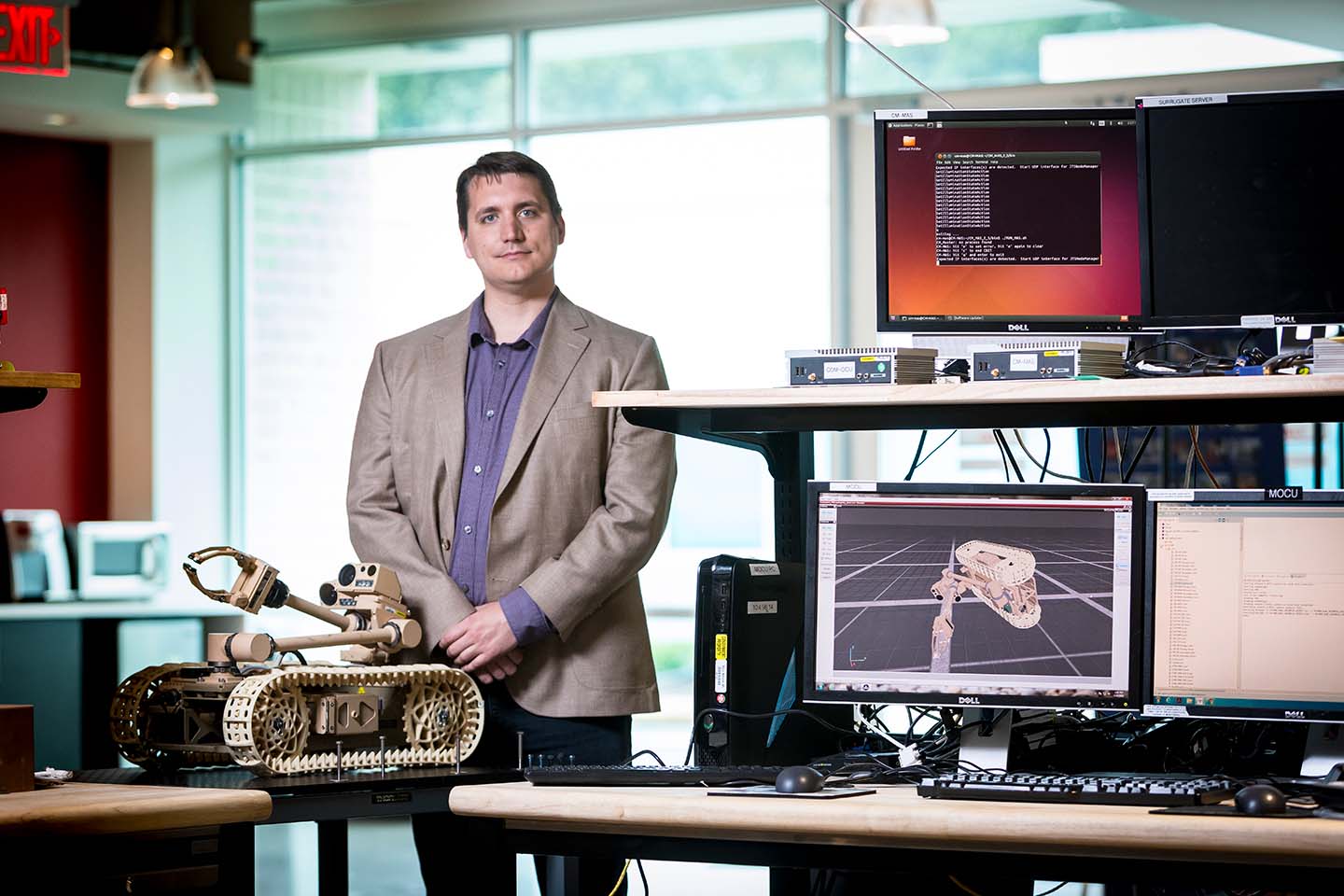 Galen Mullins poses with a robot