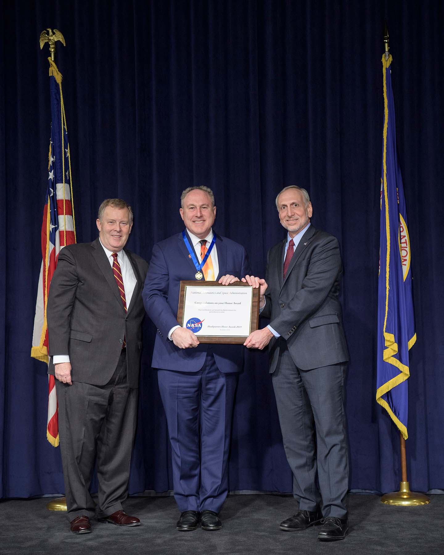 Andy Driesman of the Johns Hopkins Applied Physics Laboratory (center) receives the NASA Outstanding Public Leadership Medal for his role as project manager of Parker Solar Probe 