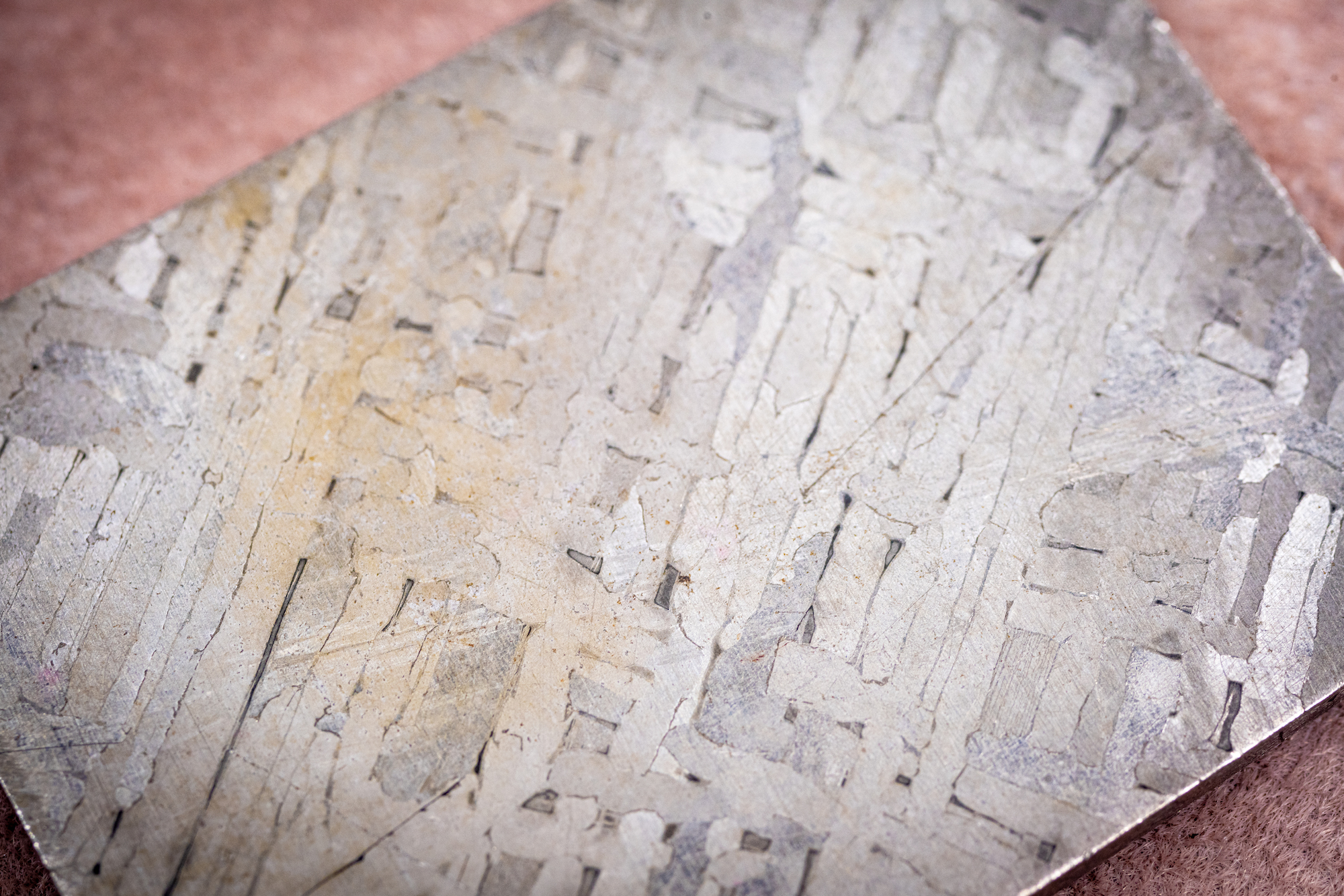 Image of the inside of an iron meteorite, showing the characteristic Widmanstätten pattern of long, iron-nickel crystals that crisscross one another. Many iron meteorites are thought to be vestiges of a planet’s core that was blasted apart early in our solar system’s evolution.  Credit: Johns Hopkins APL