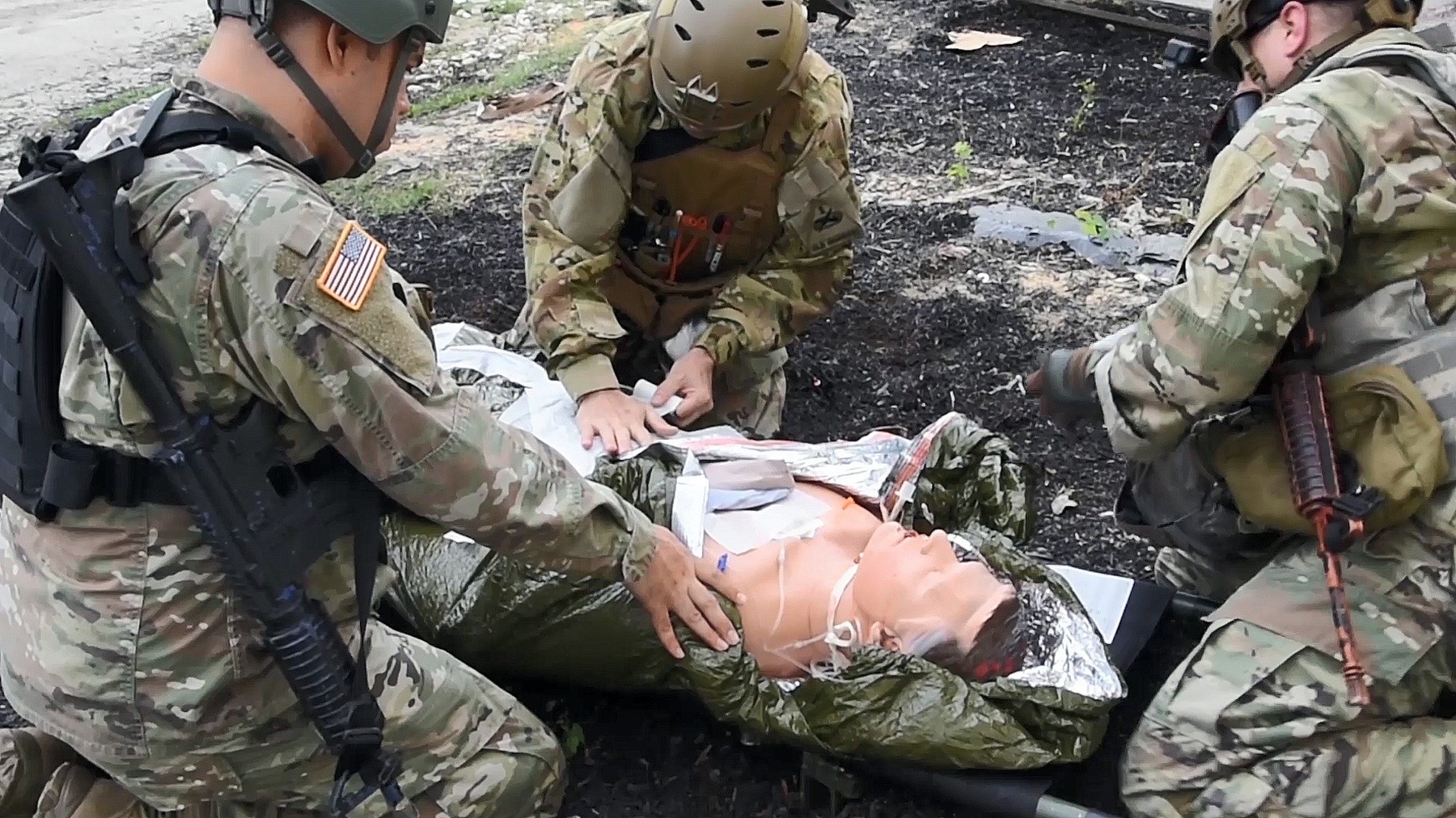 Army instructors reenact a trauma scenario.