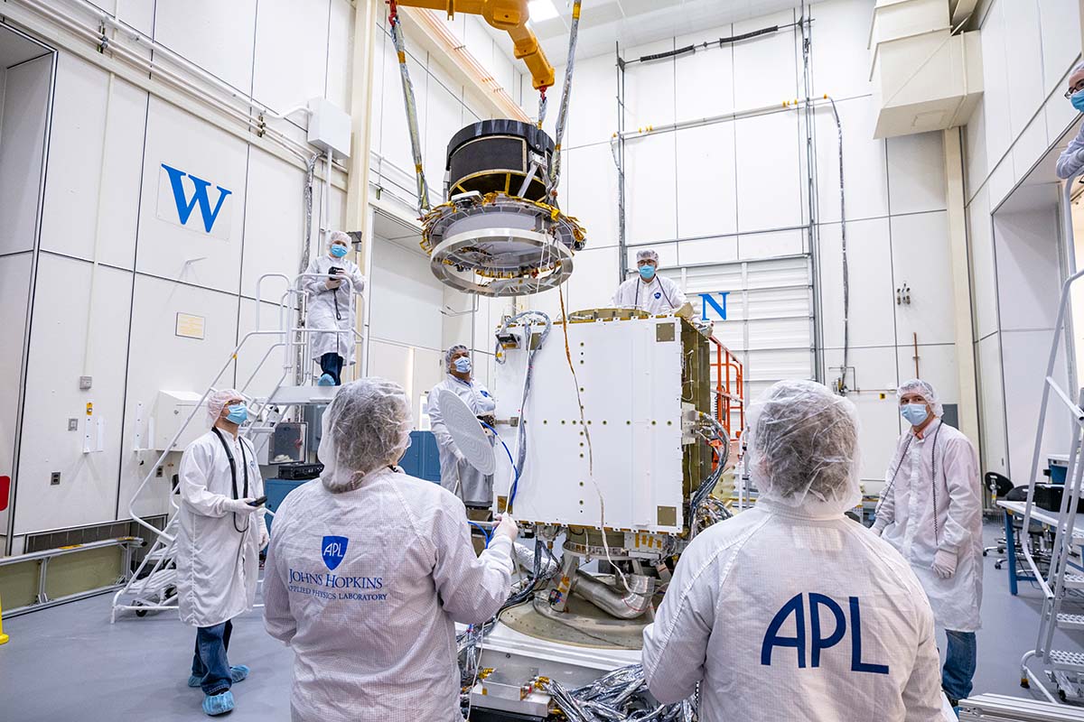 The DART team lifted the thruster bracket assembly off of the assembly table and positioned it at the top of the spacecraft