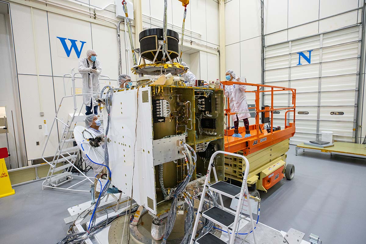 Once the NEXT-C thruster was safely lowered atop the spacecraft's central cylinder, fasteners were installed to secure the thruster to the DART spacecraft