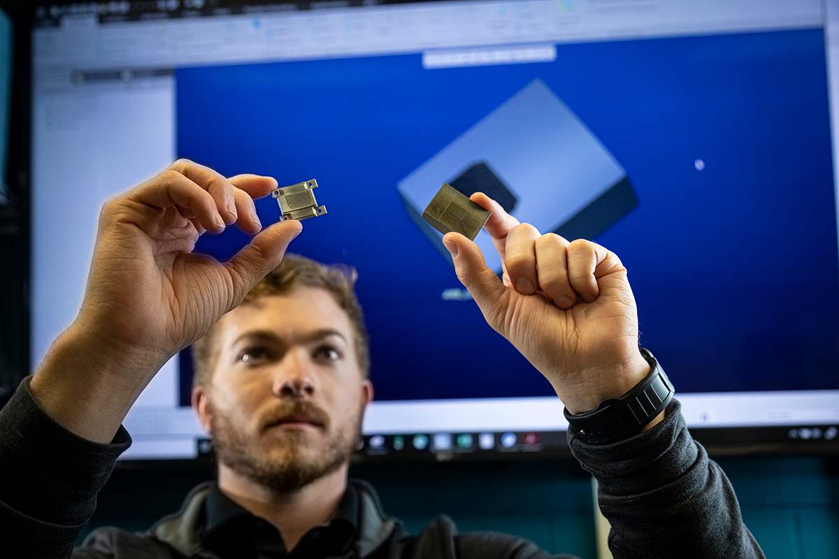 APL engineer Ryan Carter inspects a collimator segment before (right) and after (left) machining printed blank