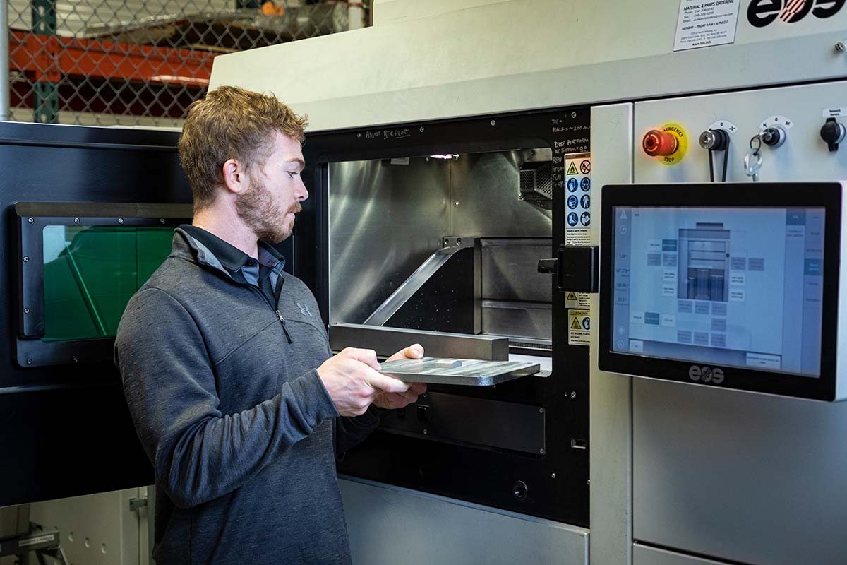 APL engineer Ryan Carter demonstrates the additive manufacturing capability required to build the delicate collimator.