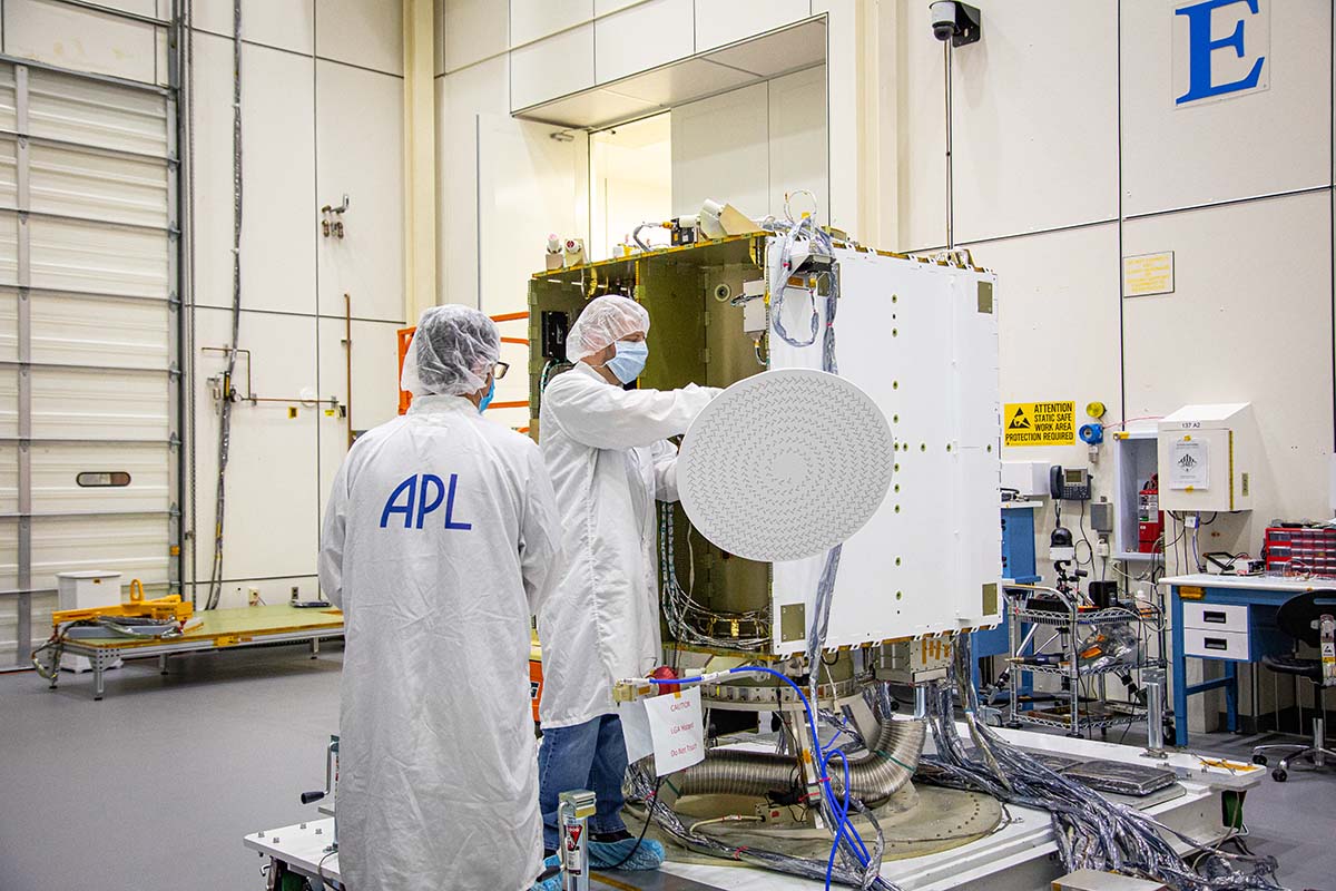 From left, APL’s Steve Wenrich and Emory Toomey finalize the installation of the RLSA on the DART spacecraft.