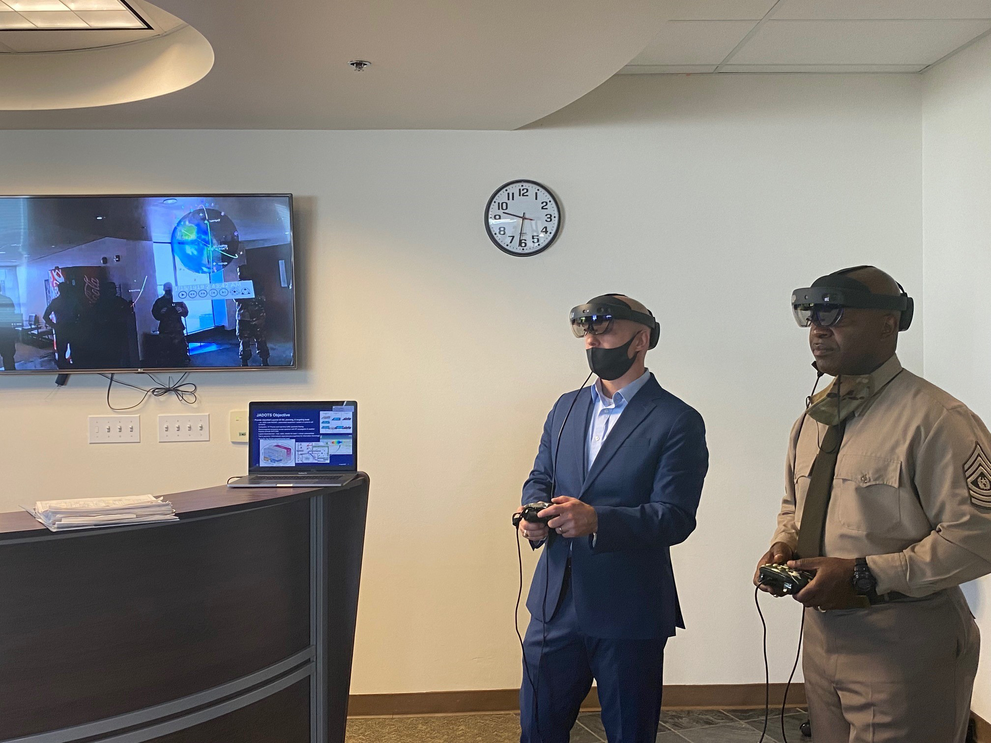 Lt. Col. Joe Mroszczyk (left) and Army Space and Missile Defense Command (SMDC) Command Sgt. Maj. Finis Dodson demonstrate an APL-developed augmented-reality, 3D-visualization capability