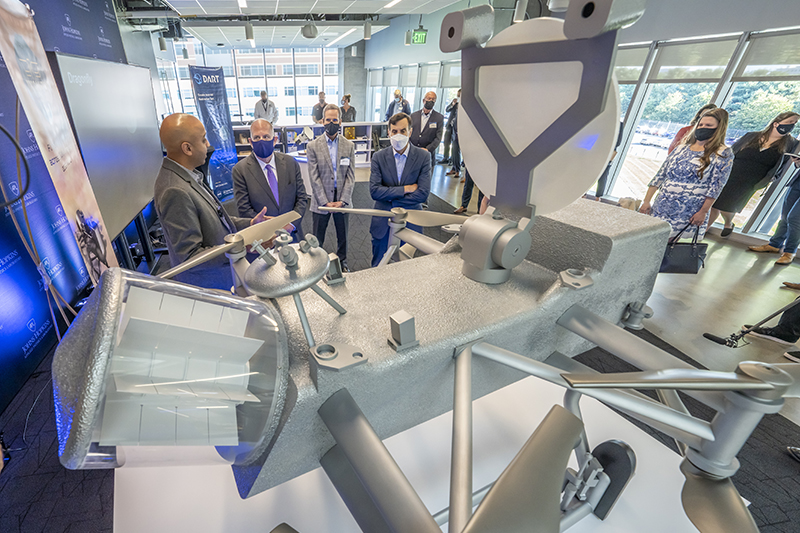 From left, Civil Space Mission Area Executive Jason Kalirai, Maryland Gov. Larry Hogan, Director Ralph Semmel and Johns Hopkins University President Ron Daniels check out a half-scale model of Dragonfly