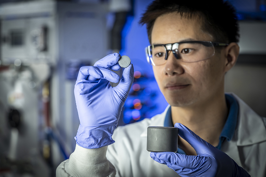 Richard Ung holds a disc of silicon-germanium