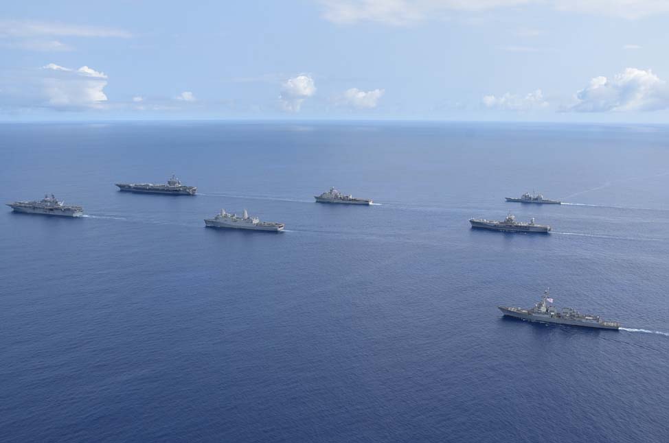 Ships from the Theodore Roosevelt Carrier Strike Group, the America Expeditionary Strike Group and the U.S. 7th Fleet command ship, USS Blue Ridge, transit the Philippine Sea in formation during an exercise on March 24. 