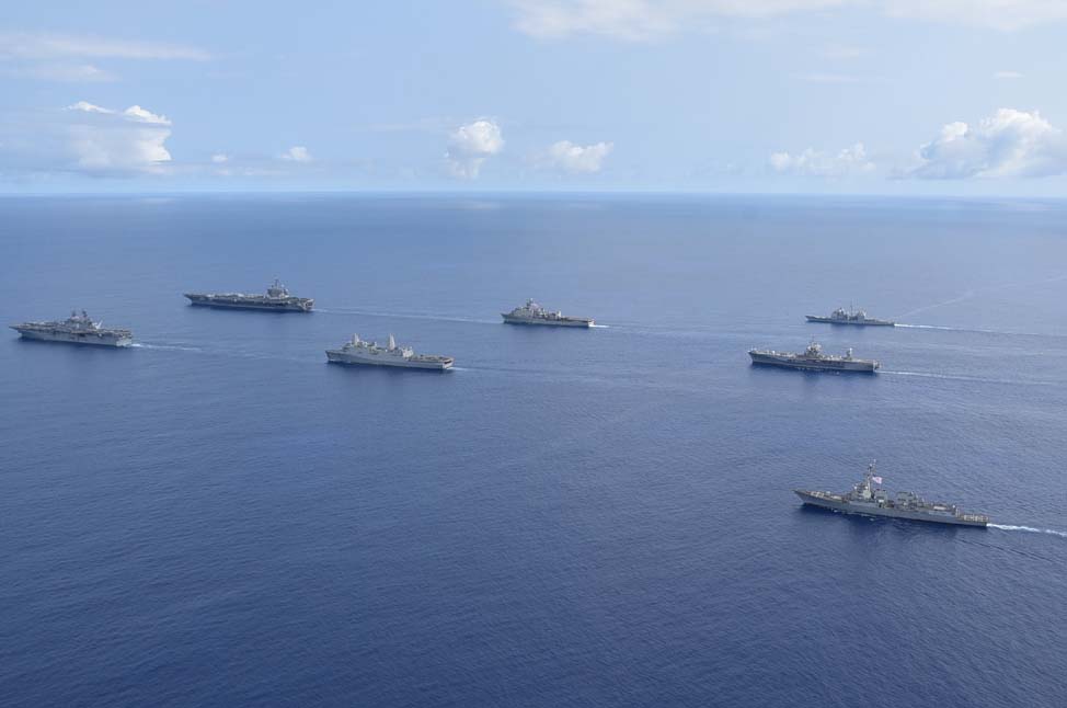Ships from the Theodore Roosevelt Carrier Strike Group, the America Expeditionary Strike Group and the U.S. 7th Fleet command ship, USS Blue Ridge, transit the Philippine Sea in formation during an exercise on March 24.