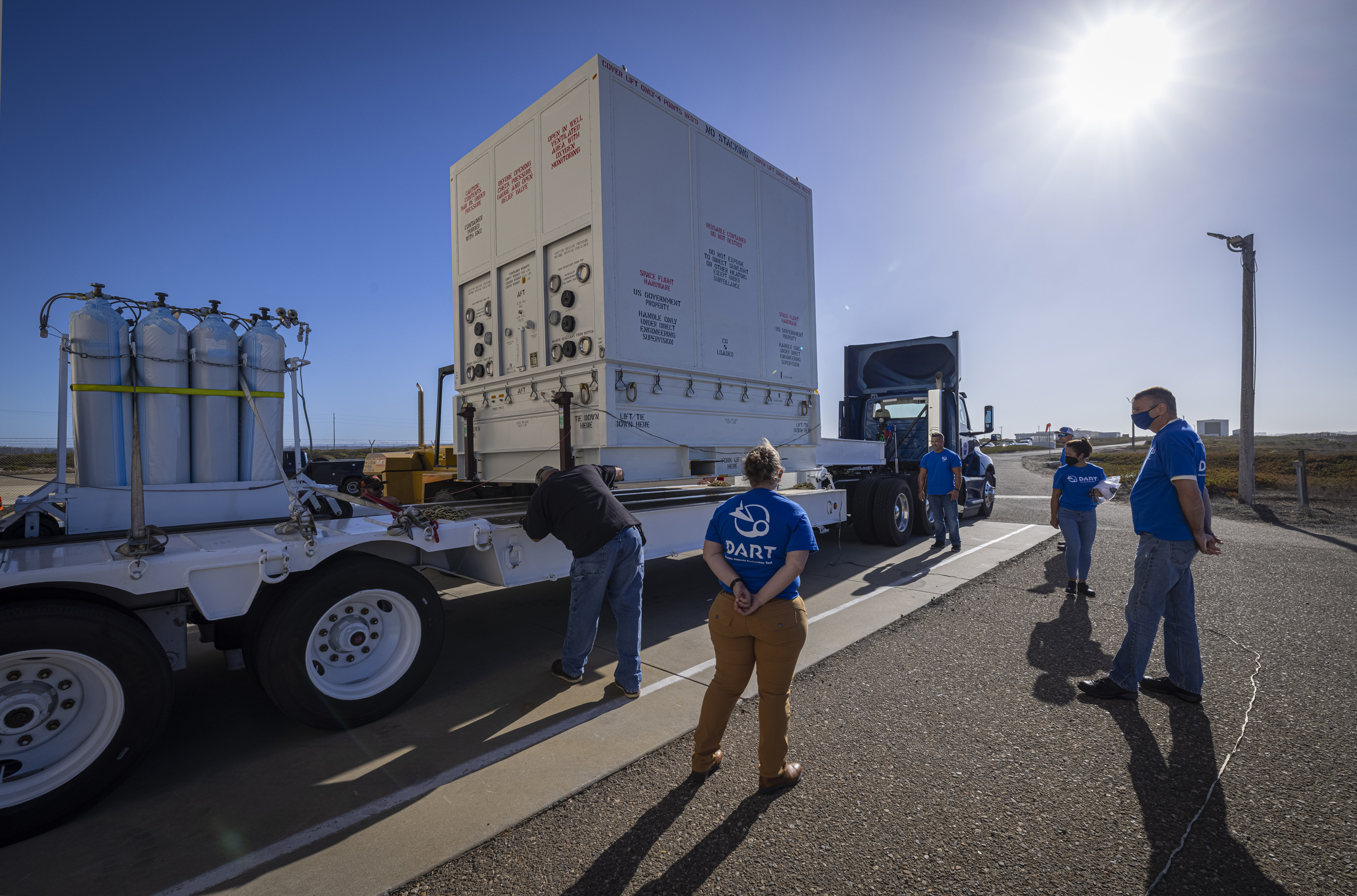 DART packed and ready to move to SpaceX. DART team members stand outside Astrotech Space Operations’ processing facility with the shipment container holding the DART spacecraft. DART moved to SpaceX’s payload processing facility late last month.  Credit: NASA/Johns Hopkins APL/Ed Whitman