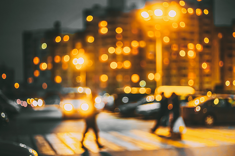 Blurry photo of people walking in a crosswalk (Credit: Bigstock)