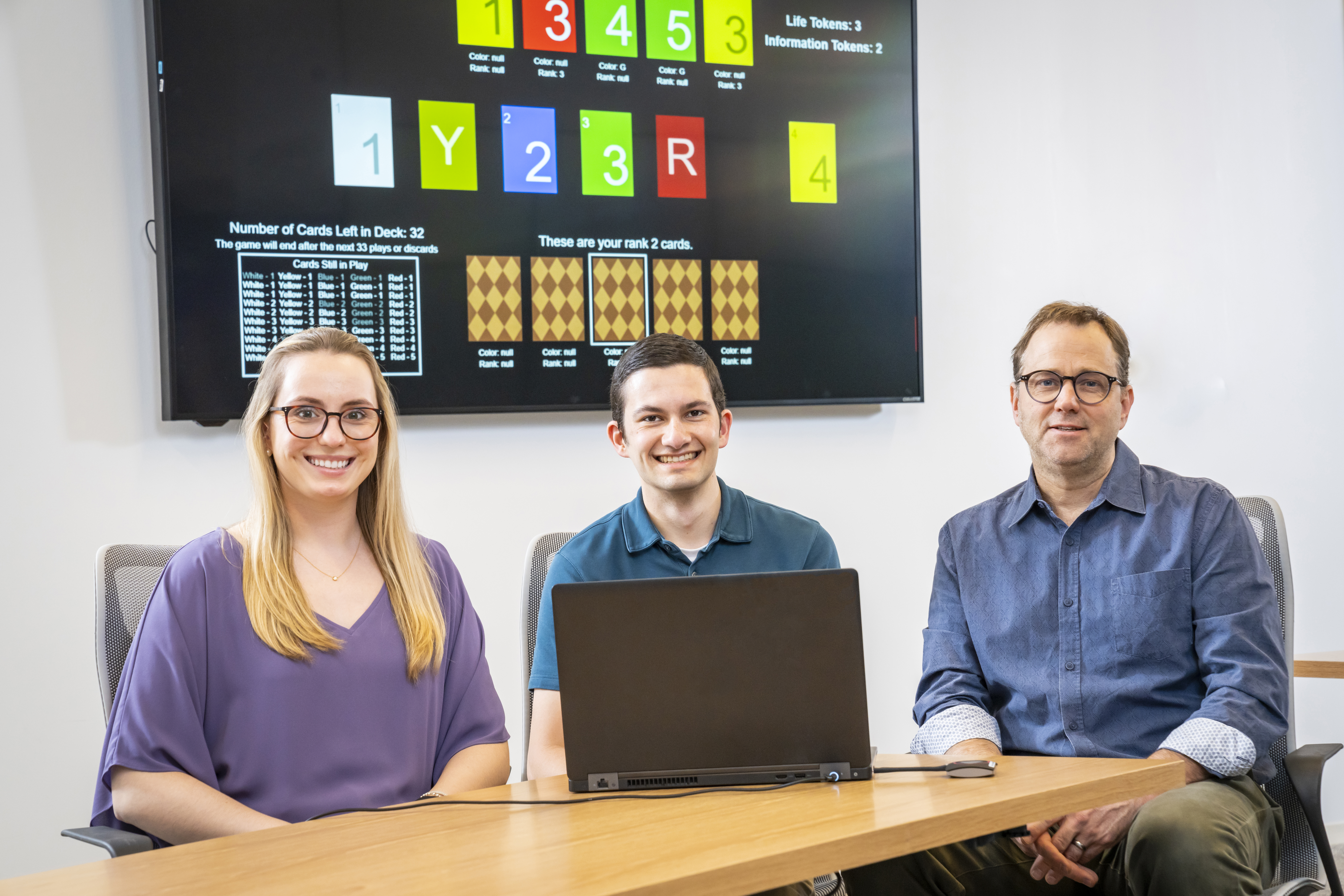 Nina Cohen, Nick Kantack and team member Nathan Bos sitting together