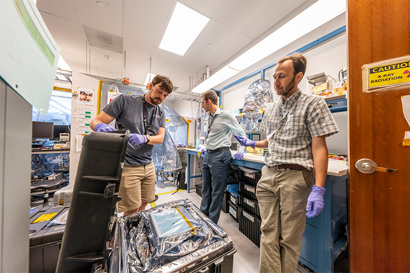 Members of the PIMS team carefully package the instrument parts