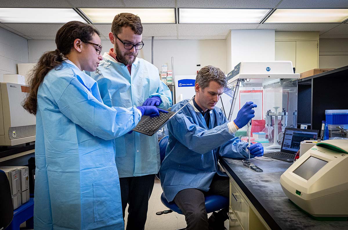 Heba Mostafa (left), assistant professor of pathology at Johns Hopkins Medicine, joins APL biologists Tom Mehoke (center) and Peter Thielen as the team initiates a sequencing of the genome of the SARS-CoV-2 virus, which causes COVID-19.
