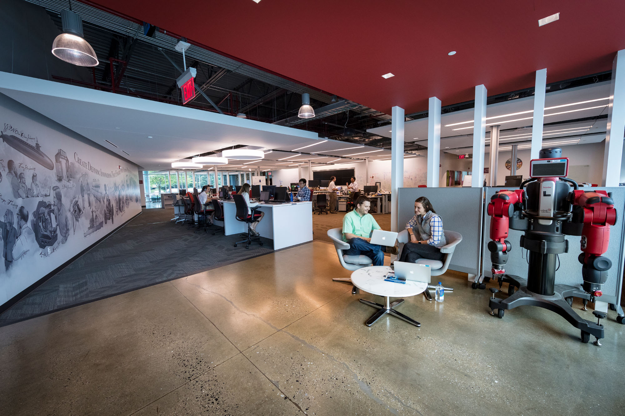 APL staff members sit at a table in an open workspace