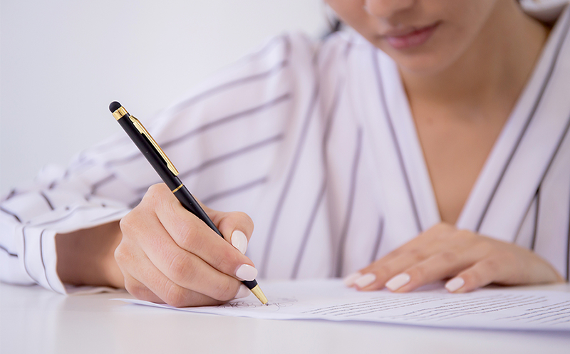 Woman writing on paper