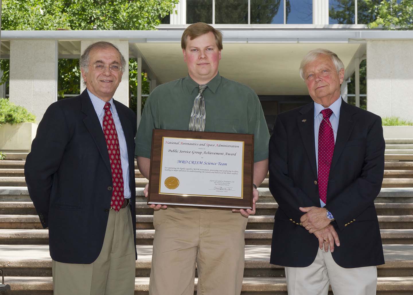 APL's Frank Seelos (center) accepts the NASA Public Service Group Achievement Award for CRISM's science team