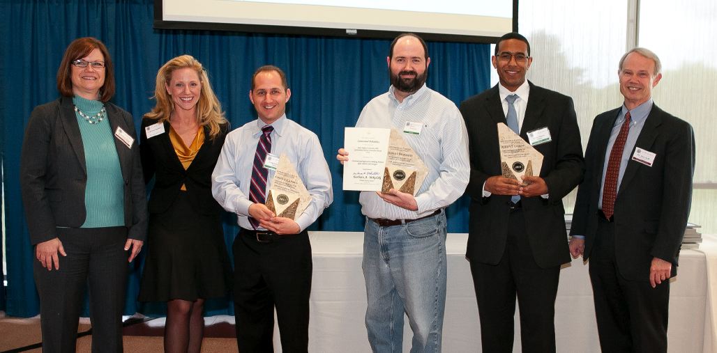 Norma Lee Todd, Office of Technology Transfer Supervisor, and Courtney Samuels, Special Assistant to Senator Barbara Mikulski (D-MD) present the Government Purpose Innovation Award to the Force Projection Department's Craig Carmen, Joshua Broadwater and Ashley Llorens 