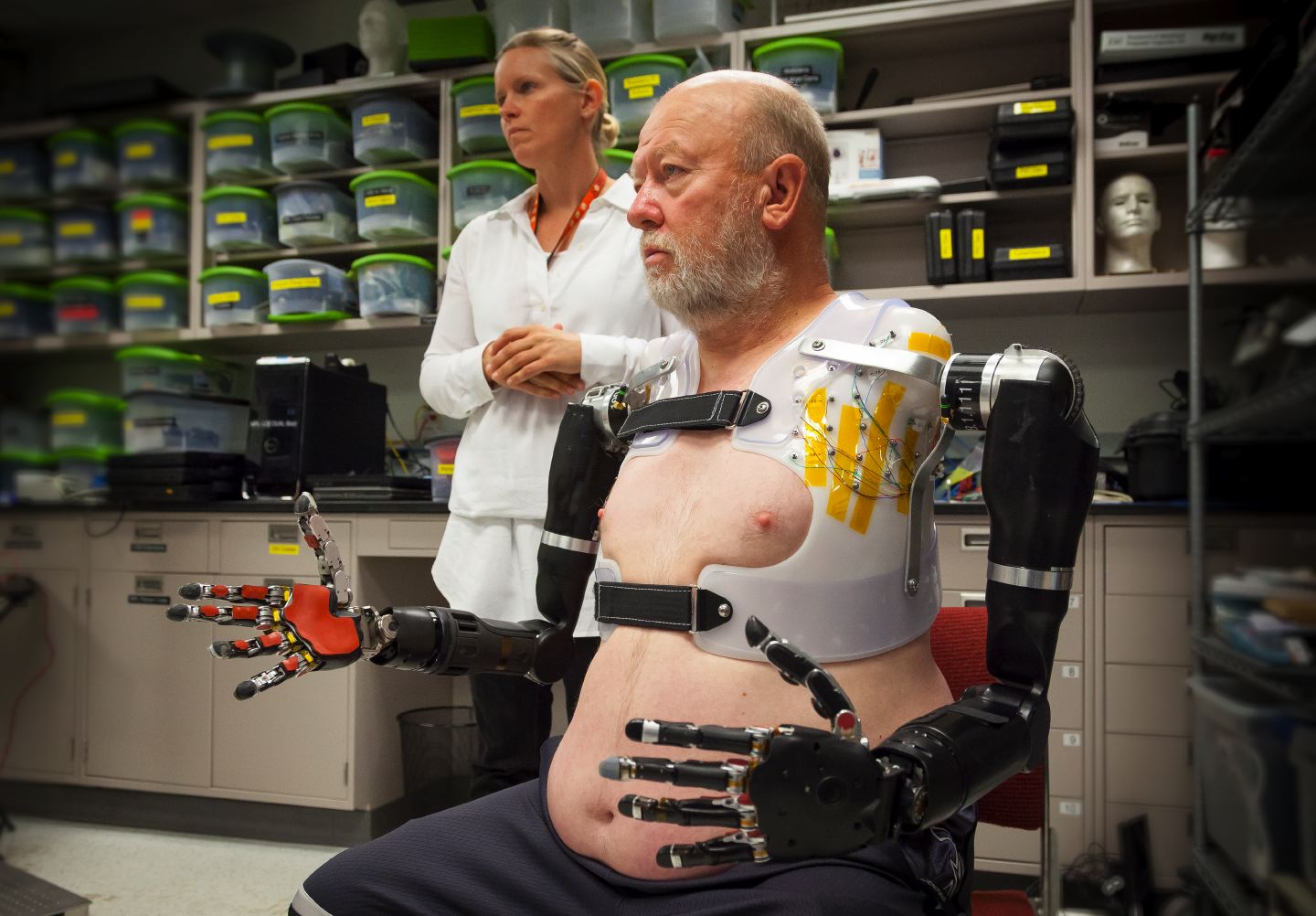 APL prosthetist Courtney Moran looks on as Les Baugh tests out the Modular Prosthetic Limbs