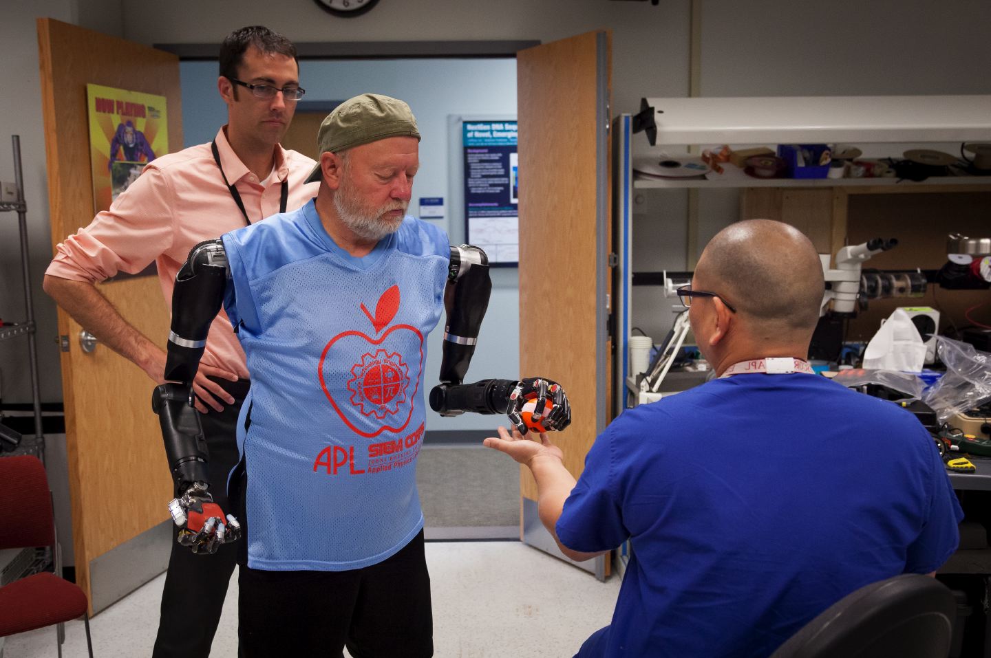 Bobby Armiger observes Baugh handing Albert Chi, M.D., a ball