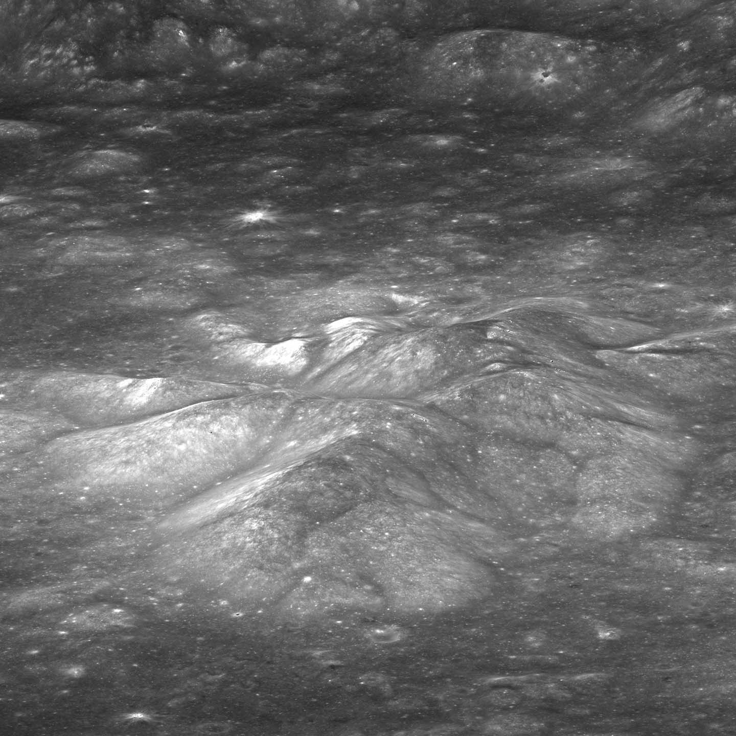 Pictured is the central peak of Bullialdus rising above the crater floor with the crater wall in the background.