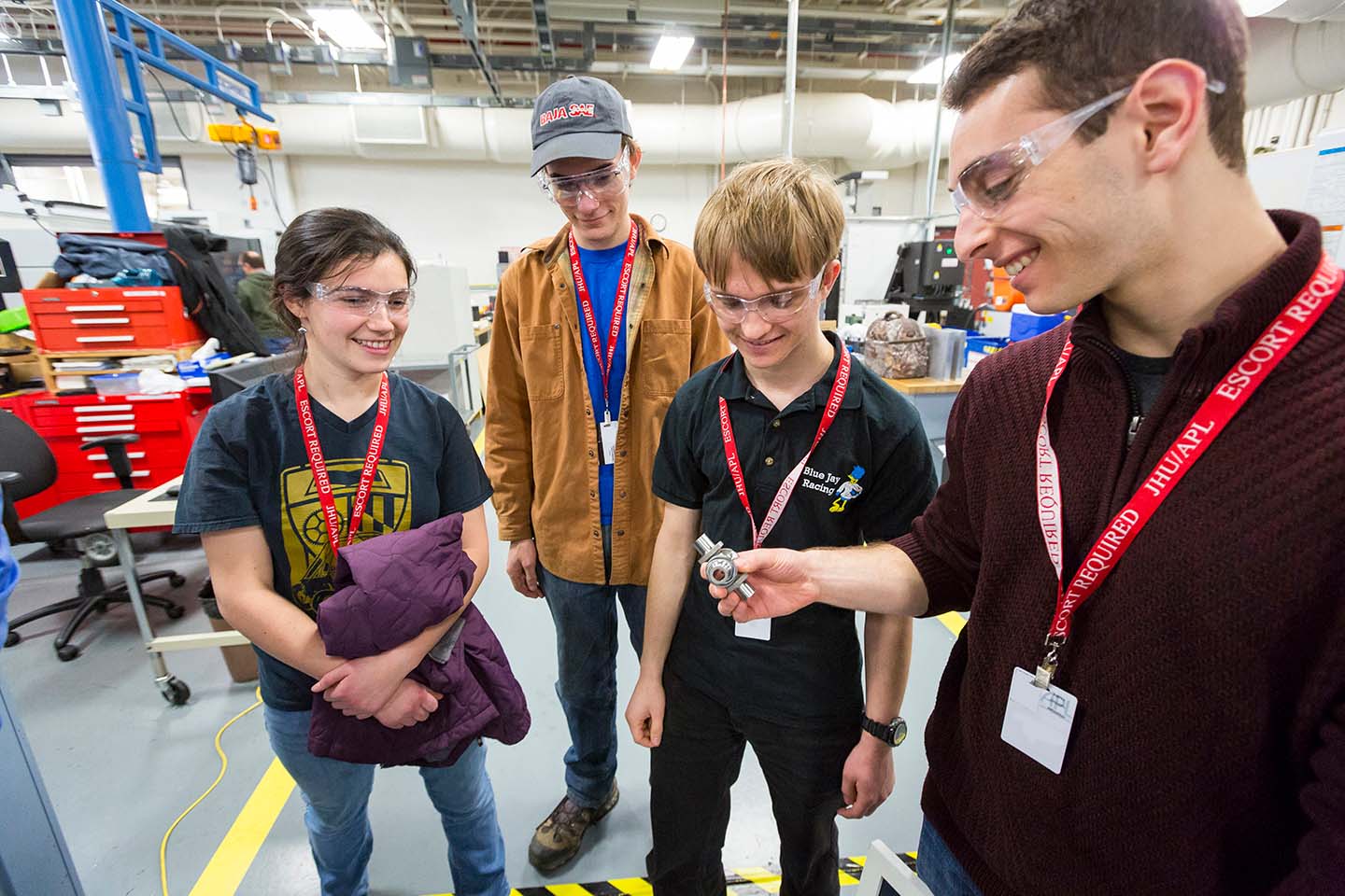 Johns Hopkins Baja team members get a look at one of the custom parts built by APL.