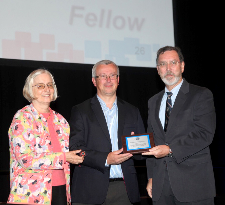 From left, INCOSE Fellows Committee Chair Dorothy McKinney and INCOSE President Alan Harding present a Fellows plaque to APL’s Ron Luman