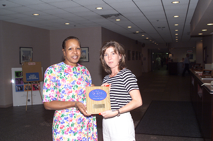 Maggie Sands (left), of the Air Defense Systems Department, is honored by the March of Dimes