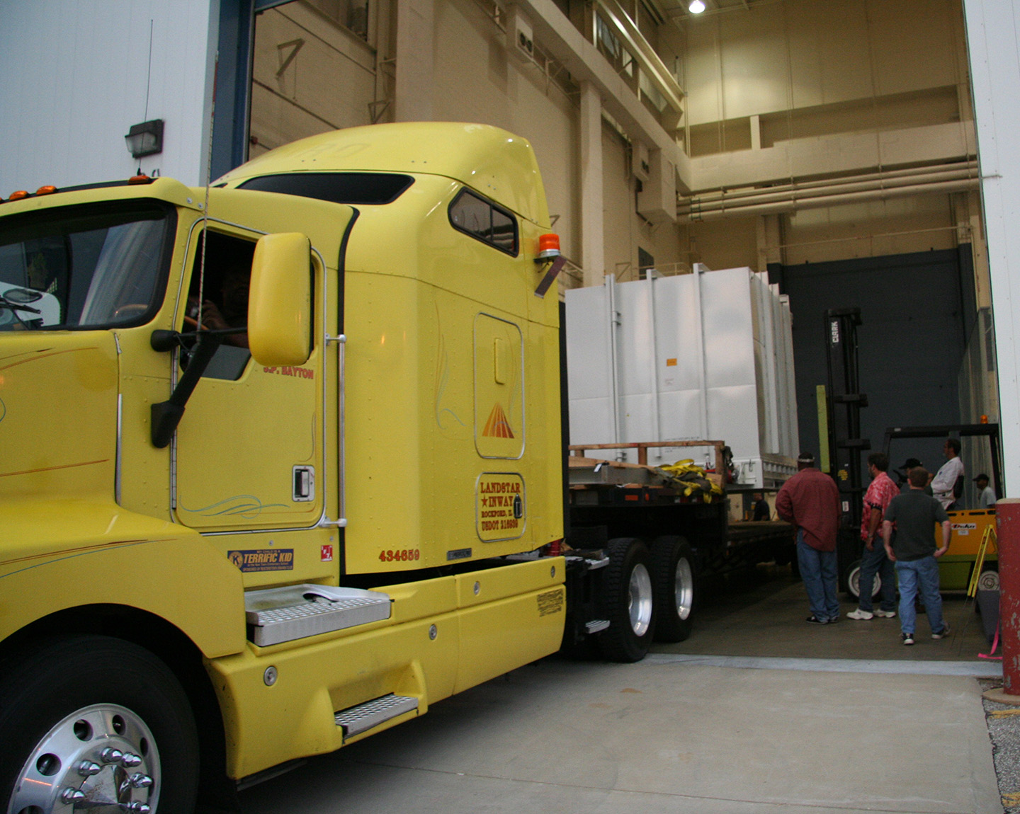 Packed safely in a pressurized shipping container, the New Horizons spacecraft is loaded onto a flatbed truck at NASA's Goddard Space Flight Center