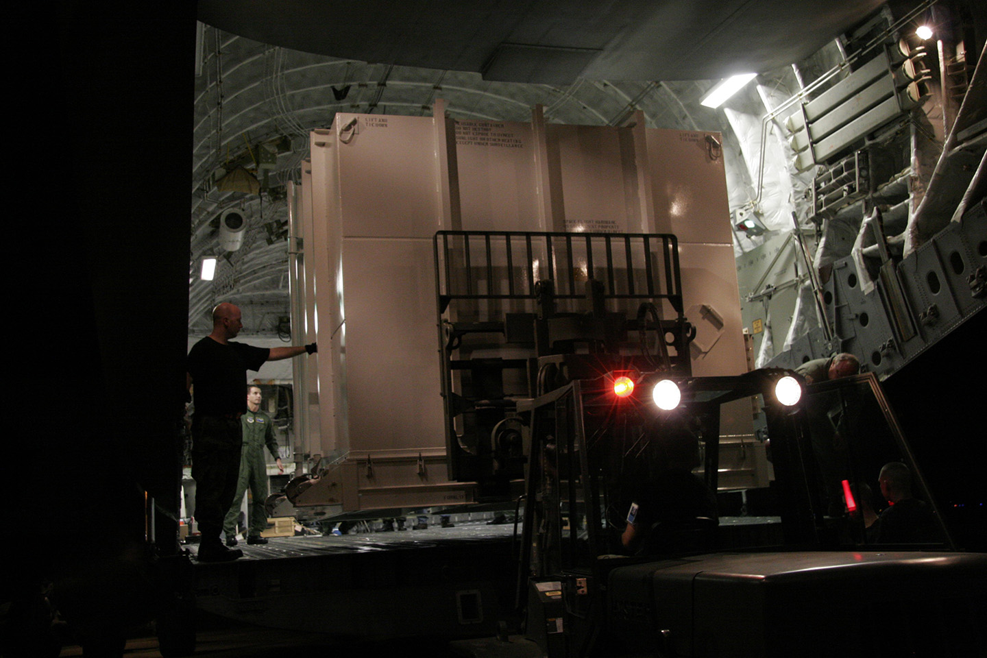 NASA's New Horizons spacecraft is loaded into a C-17 cargo plane