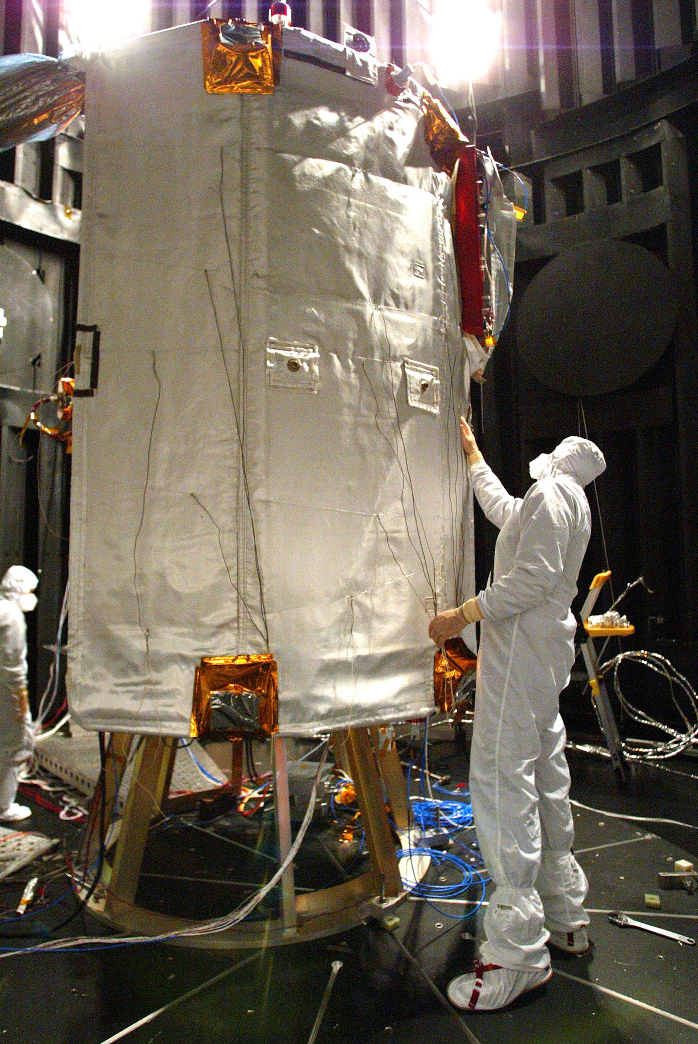 Jack Ercol, MESSENGER lead thermal engineer from The Johns Hopkins University Applied Physics Laboratory, checks the condition of the spacecraft's ceramic-fabric sunshade after testing in the thermal-vacuum chamber at NASA's Goddard Space Flight Center.