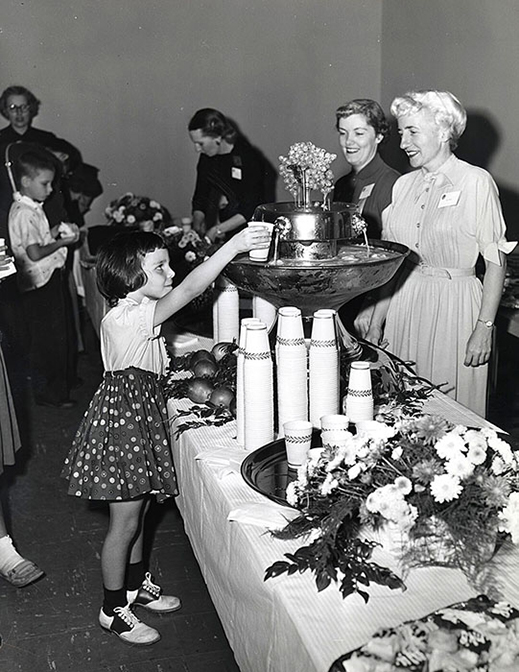 A young visitor reaches for a drink at the Lab’s first Family Day event