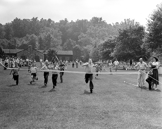 Youngsters race to the finish line during the 100-yard dash at the annual APL picnic