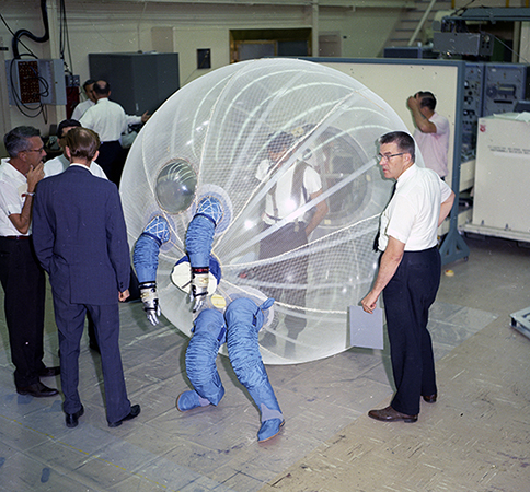 A volunteer steps into the Non-Anthropomorphic Space Exploration Suit (1965)