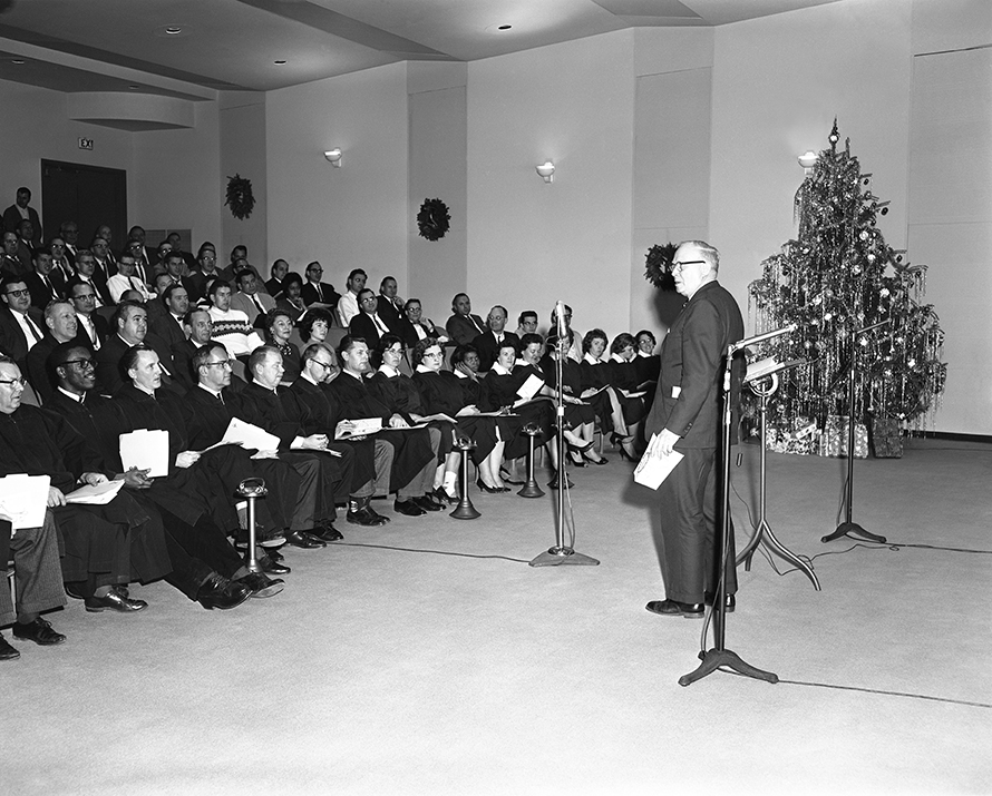 Director Ralph Gibson addresses the audience and the APL Choral Group at the Laboratory Christmas program in 1963.