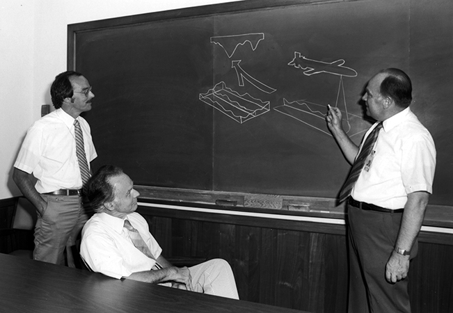 William Spohn (right) with an illustration showing the basic operation of the TERCOM system