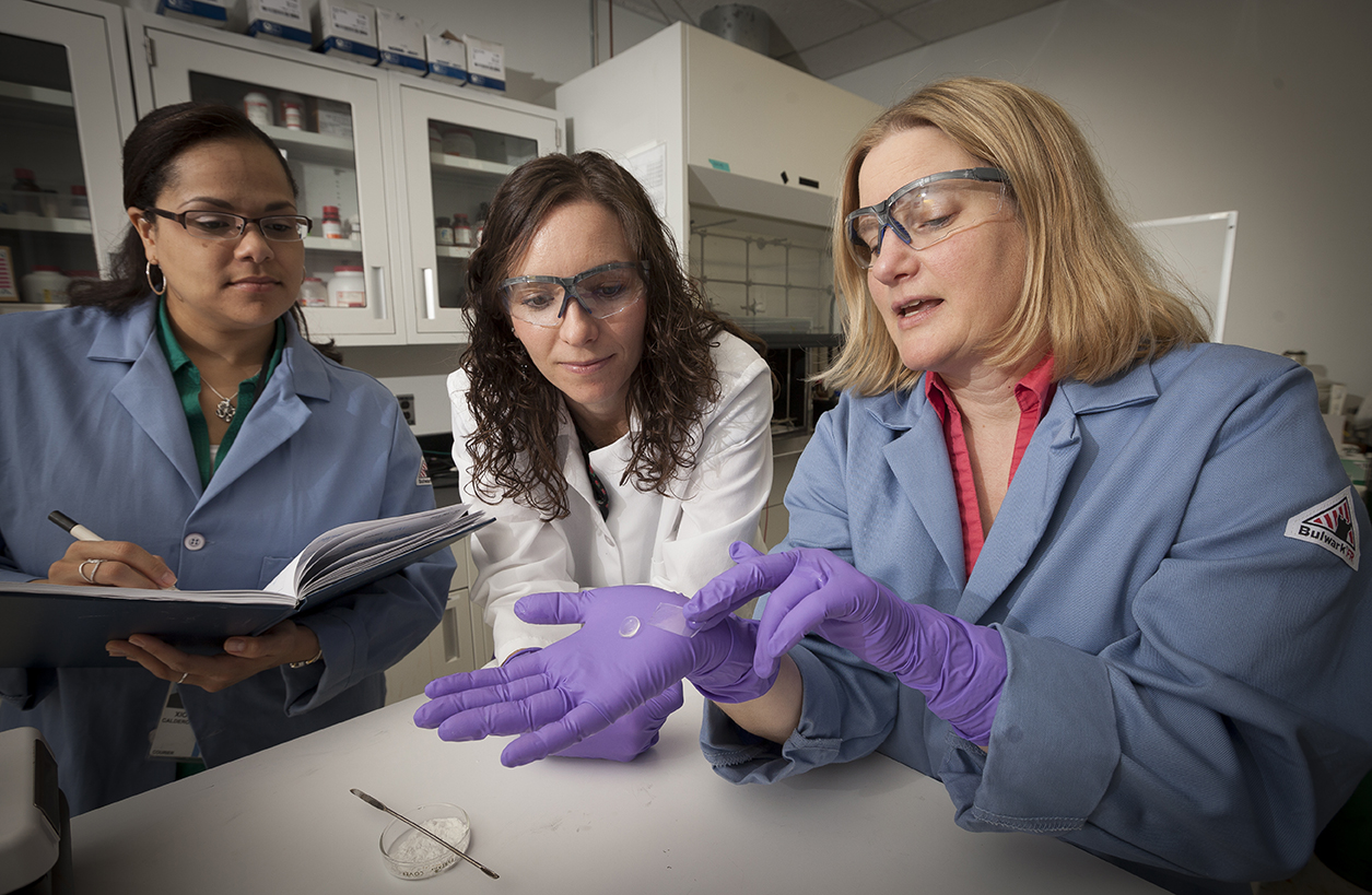 From left, the Lab’s Xiomara Calderon-Colon, Morgan Trexler, and Marcia Patchan fine-tune the cellulose bandage their team developed to protect soldiers’ injured eyes on the battlefield.